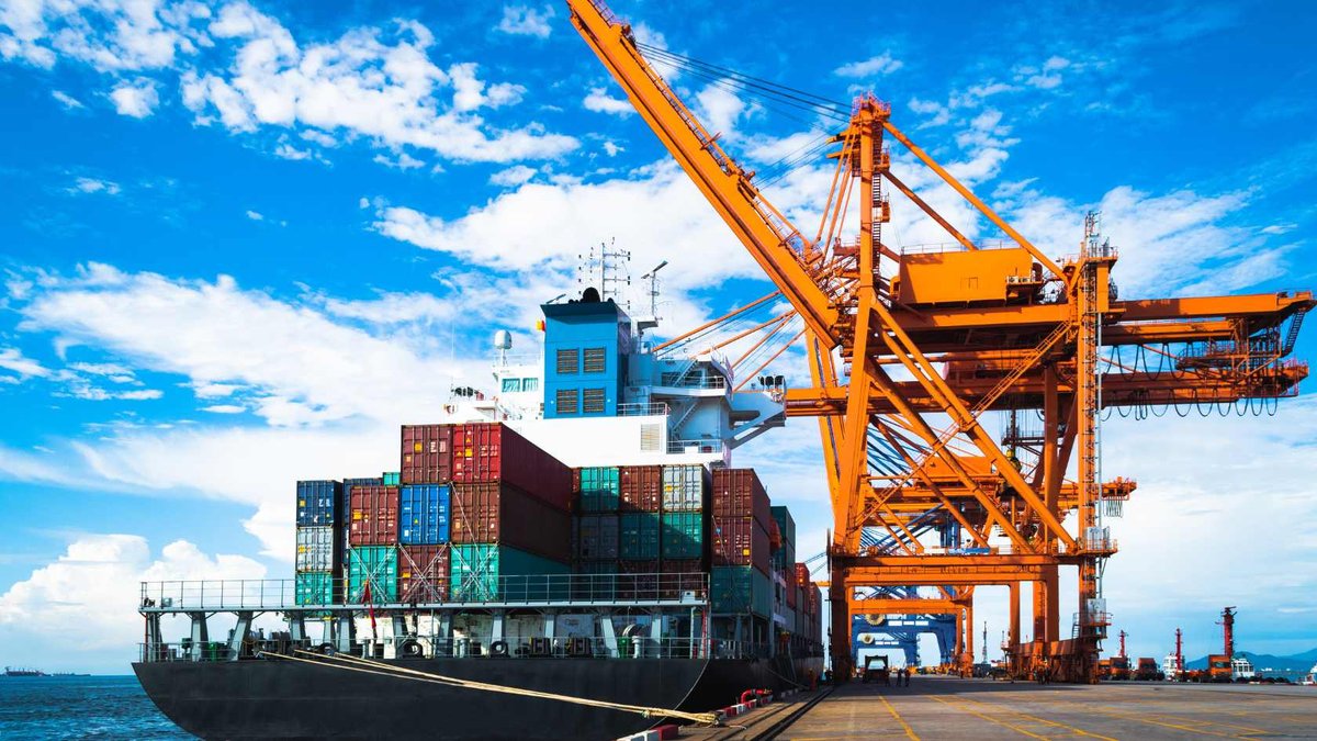 Container ship alongside port cranes